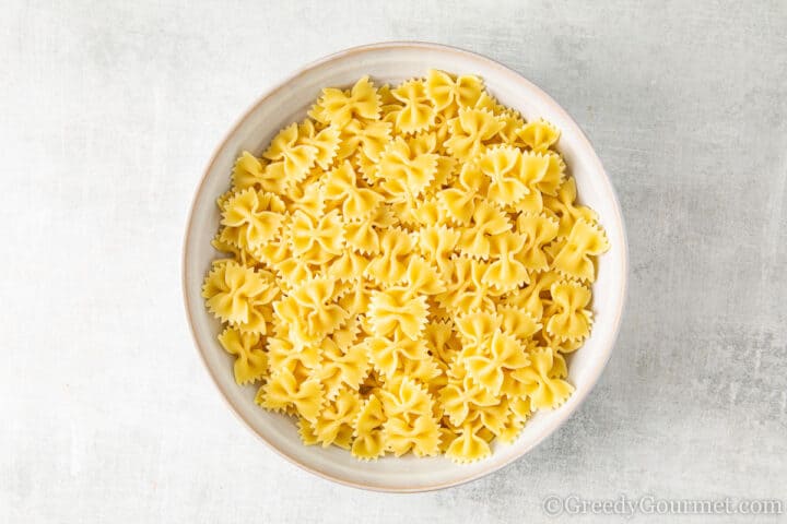 Bowl of boiled farfalle to make a greek salad