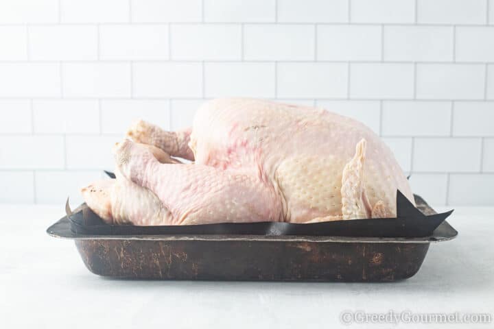 Whole Roast Turkey uncooked in baking dish