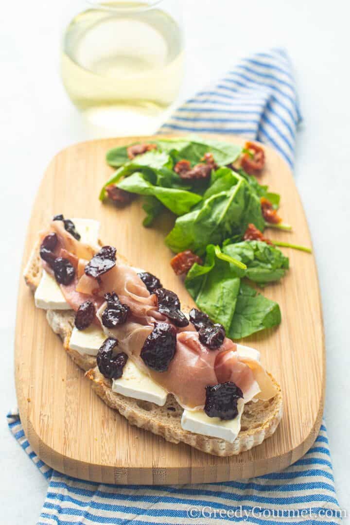 bread with cheese and chutney on cutting board