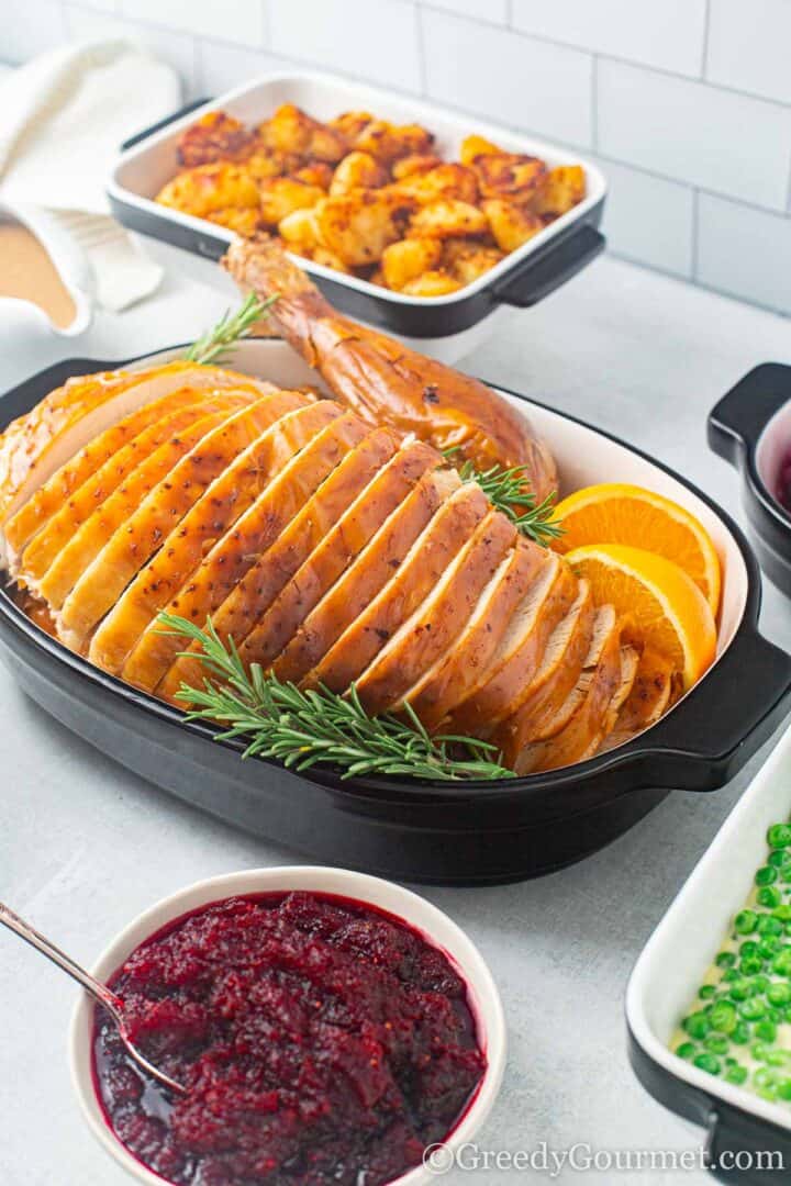 Whole roast turkey with cranberry sauce on side