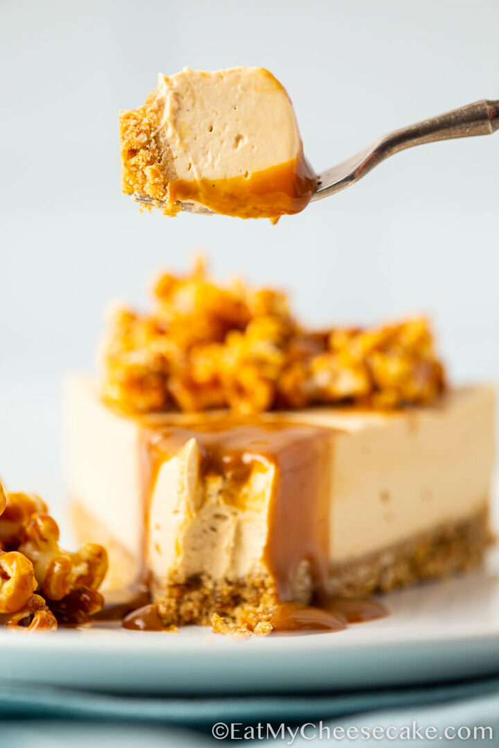 cheesecake decorated with popcorn and caramel sauce.