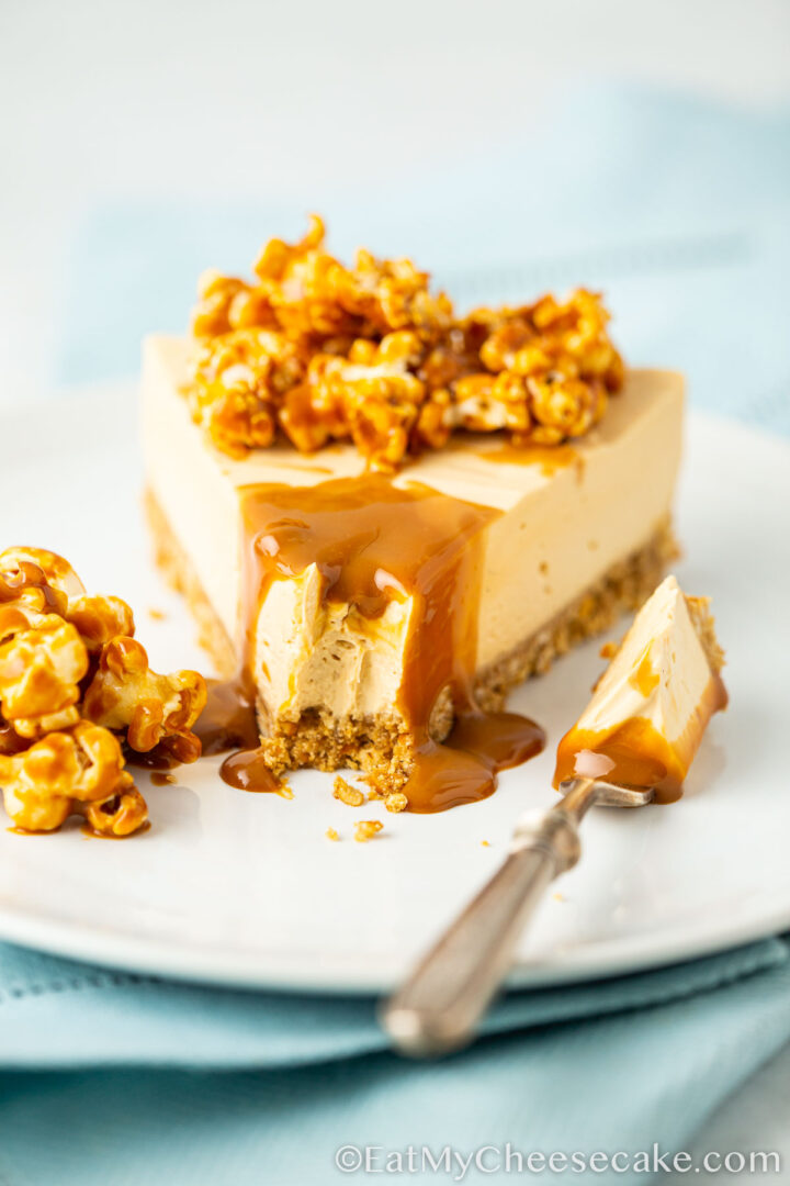 cheesecake decorated with popcorn and caramel sauce.
