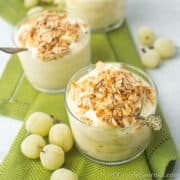 Two glass bowls full of a creamy white goosebury fool