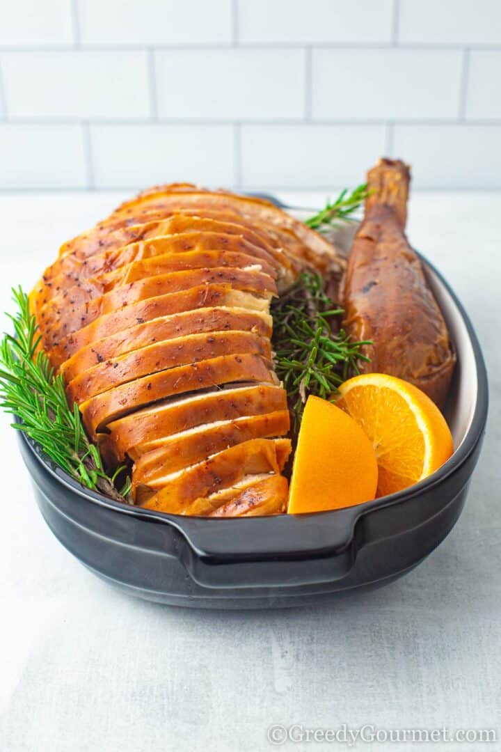 Whole Roast Turkey served with orange slices and rosemary