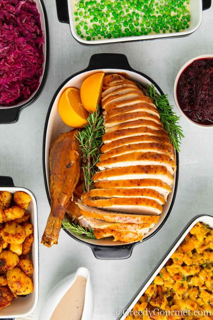 Whole Roast Turkey with rosemary and orange wedges.