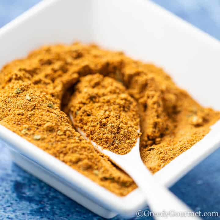 Close up of a spoonful of old bay seasoning.