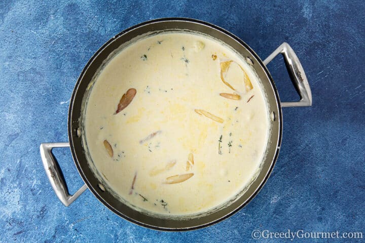 Boiling cream in a cooking pot.