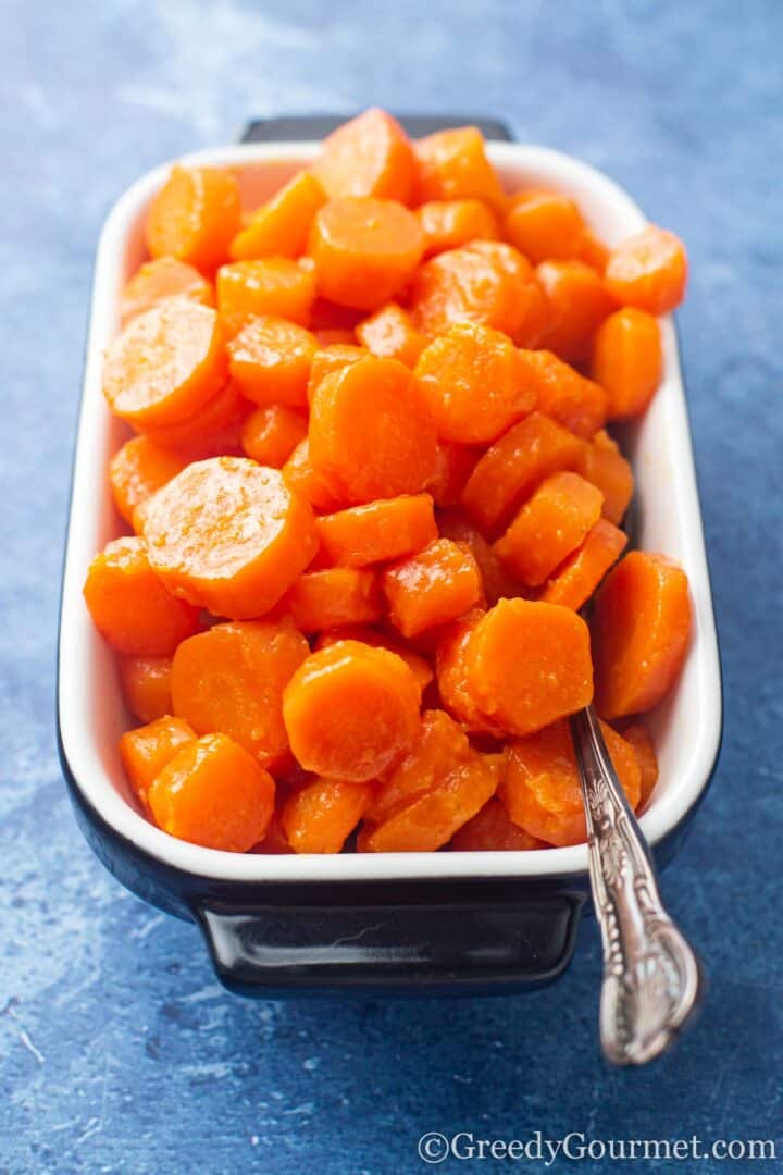 cooked maple glazed carrots in a dish ready to be served