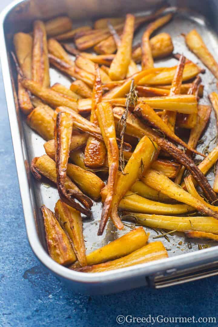 Cooking honey roasted parsnips.