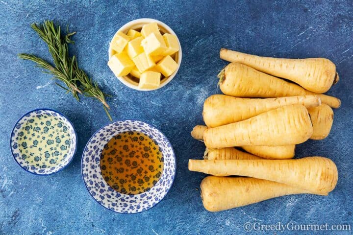 ingredients for honey roasted parsnips laid on a table.