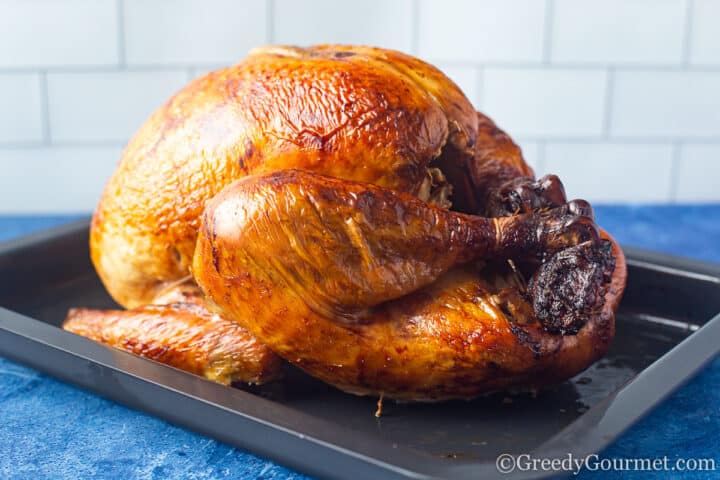 whole roasted turkey on a cooking tray.