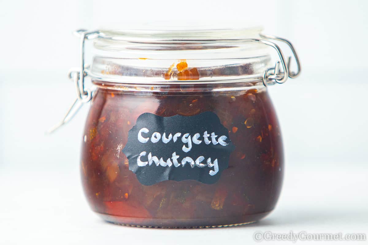 Courgette chutney in a glass jar.