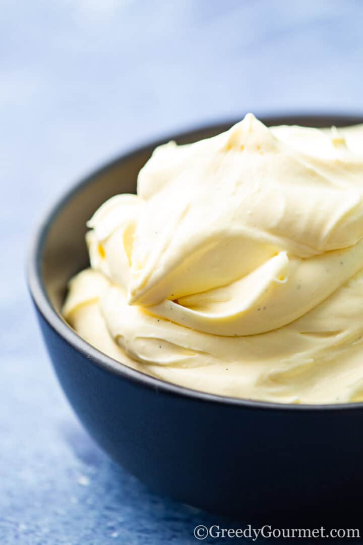 close up image of eggnog ice cream in a dark grey bowl