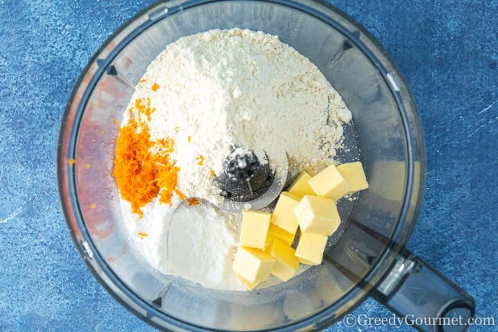 flour butter and orange rinds in a mixer.