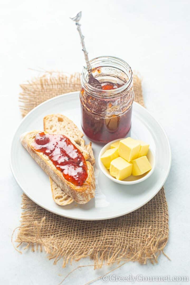 Gooseberry jam on bread slices with butter.