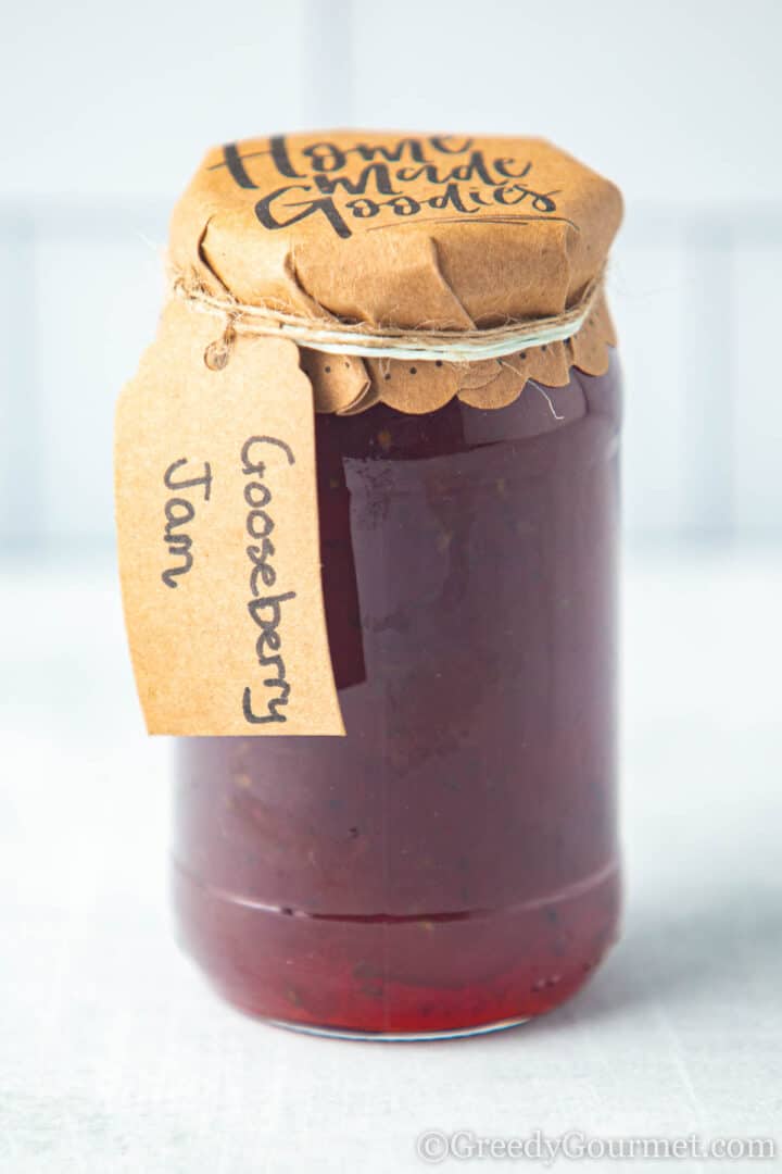 Gooseberry jam in a labelled glass jar.