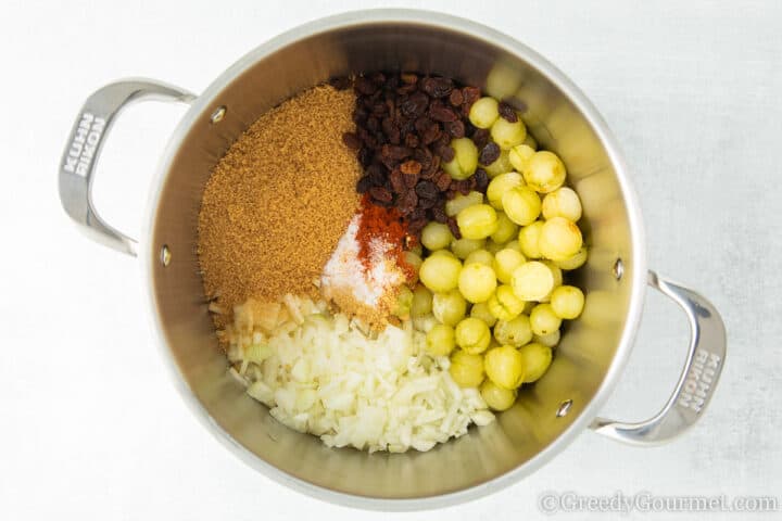 ingredients for gooseberry chutney in a cooking pot.