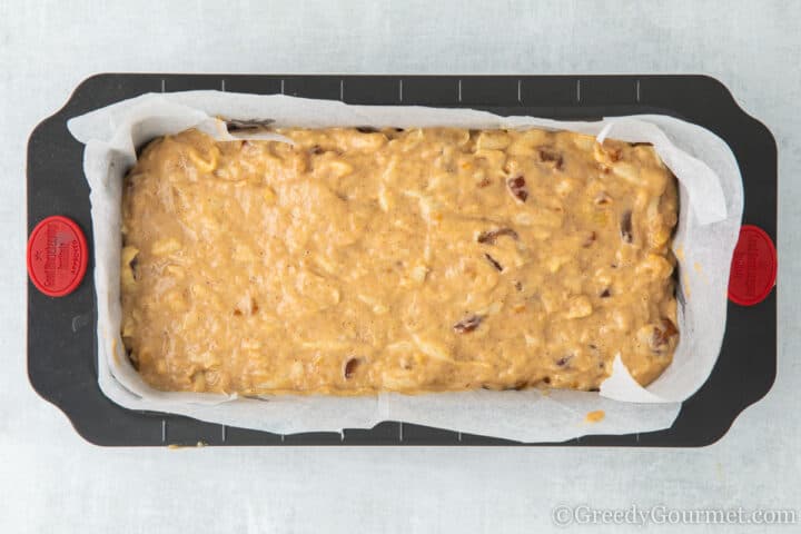 Raw marrow cake batter in a loaf tin.