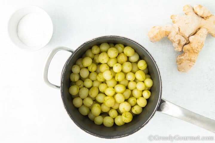 sugar gooseberries and ginger in a pot.