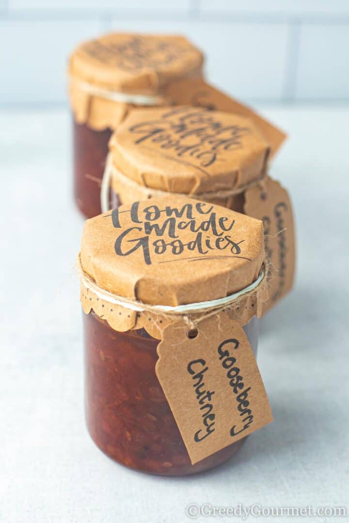 Gooseberry chutney in labelled glass jars.