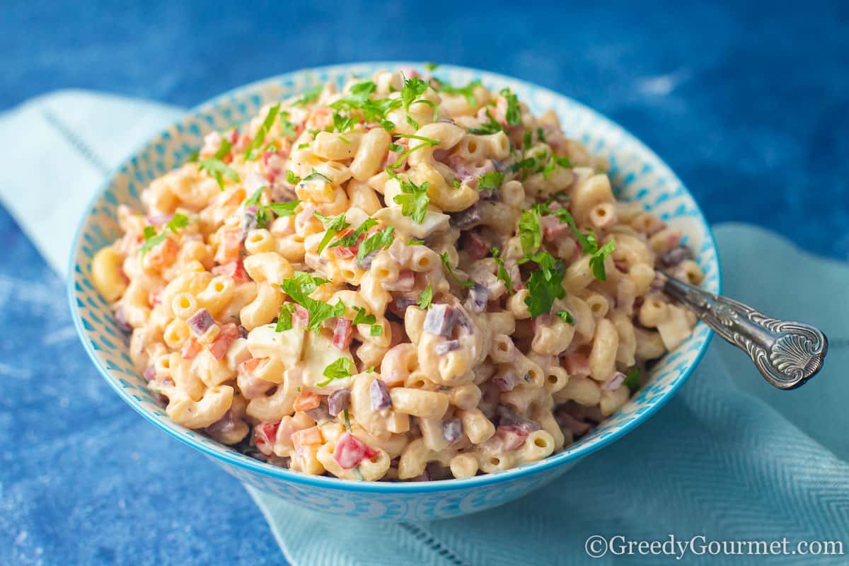 Macaroni and cheese salad in a blue bowl.