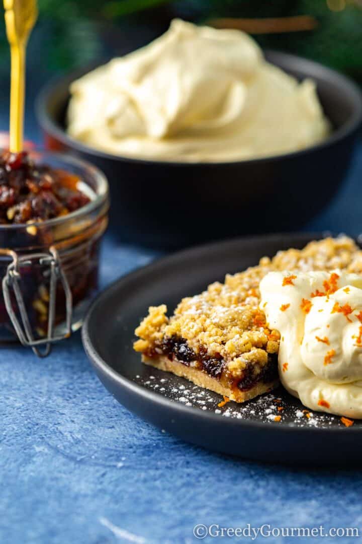 eggnog ice cream in a grey bowl with a pastry, larger bowl of ice cream in background