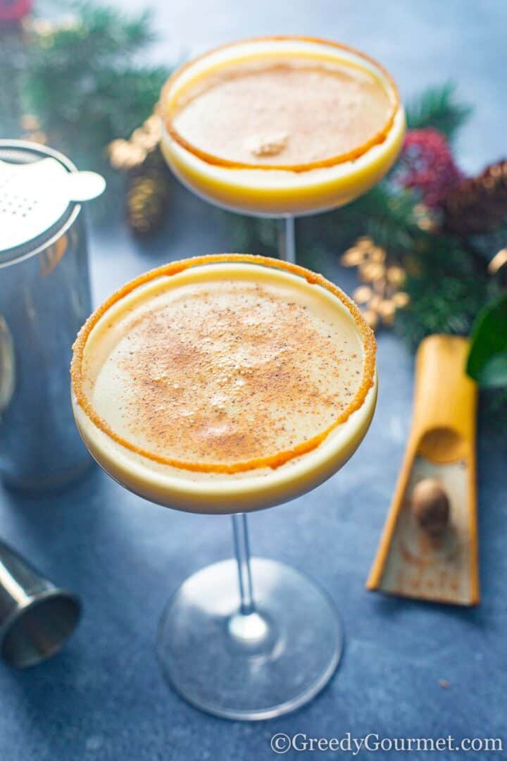 an eggnog martini with cinnamon sprinkled on top