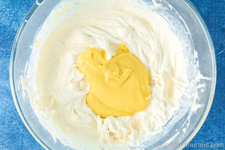 Adding eggnog pate to whipped cream.