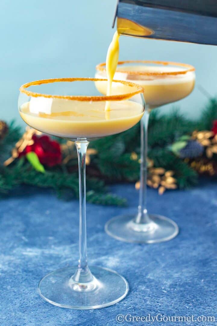 eggnog martini being poured into a glass