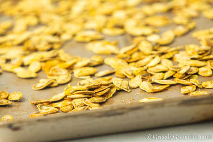 Roasted marrow seeds on a baking tray.