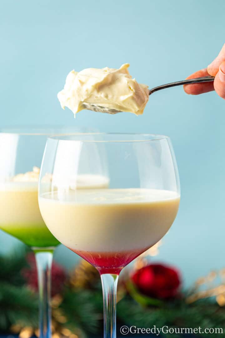 adding eggnog cream to a glass of rumchata eggnog