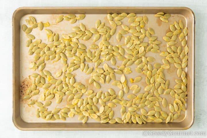 Washed marrow seeds laid on a baking tray.