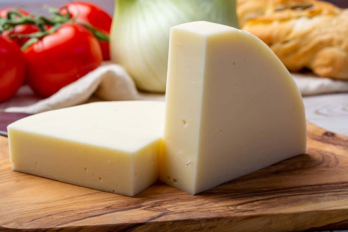 slices of provolone dolce with tomatoes