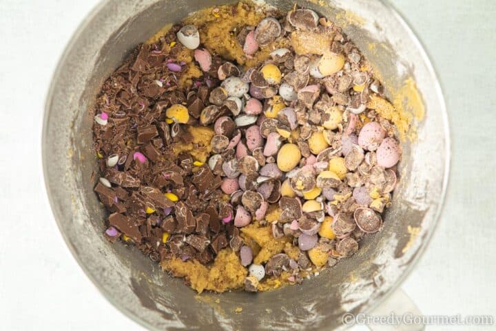 adding chocolate mini eggs to the cookie dough.