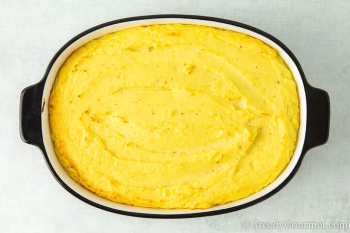 Baked mash potatoes in a serving dish.