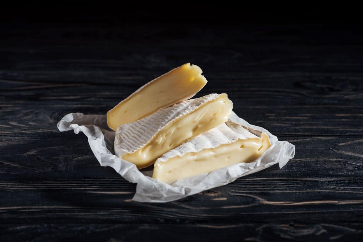 Brie slices on a white cheesecloth.