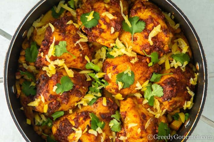 Cooked one pot Harissa chicken topped with cilantro.