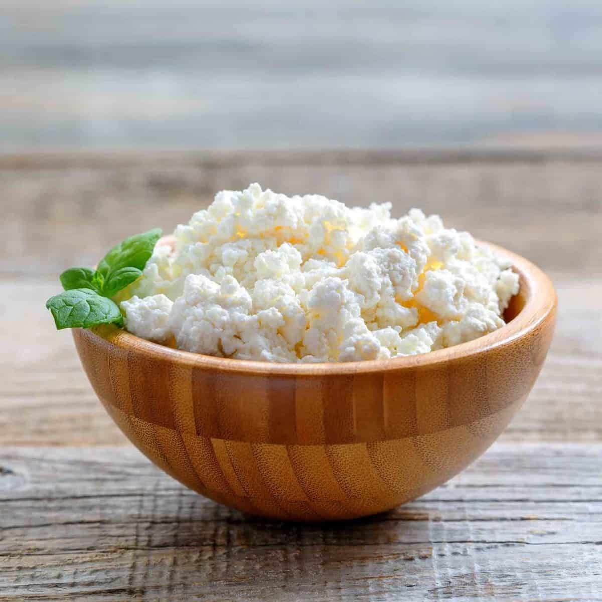 Wooden bowl filled with Cottage Cheese.
