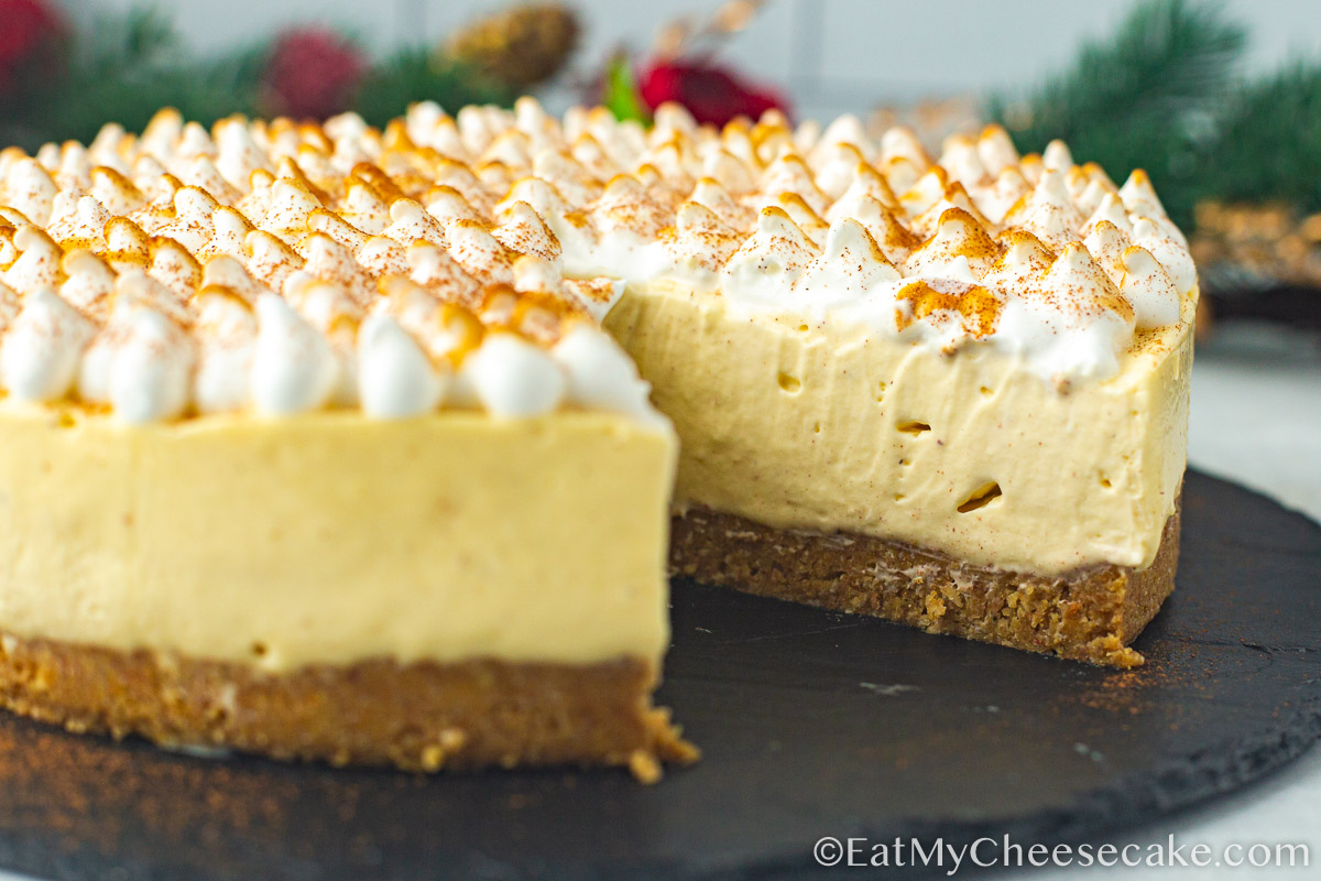 eggnog cheesecake with a slice cut out.