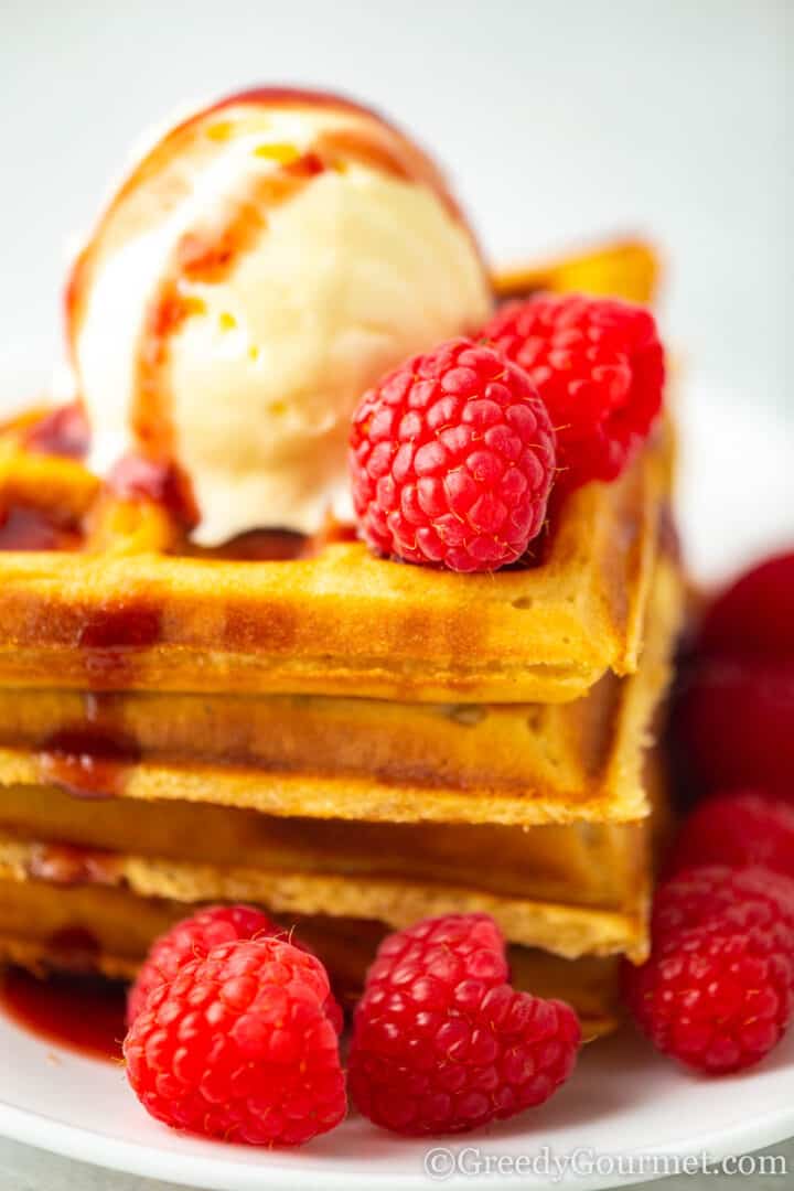 eggnog waffles with ice cream and raspberries.