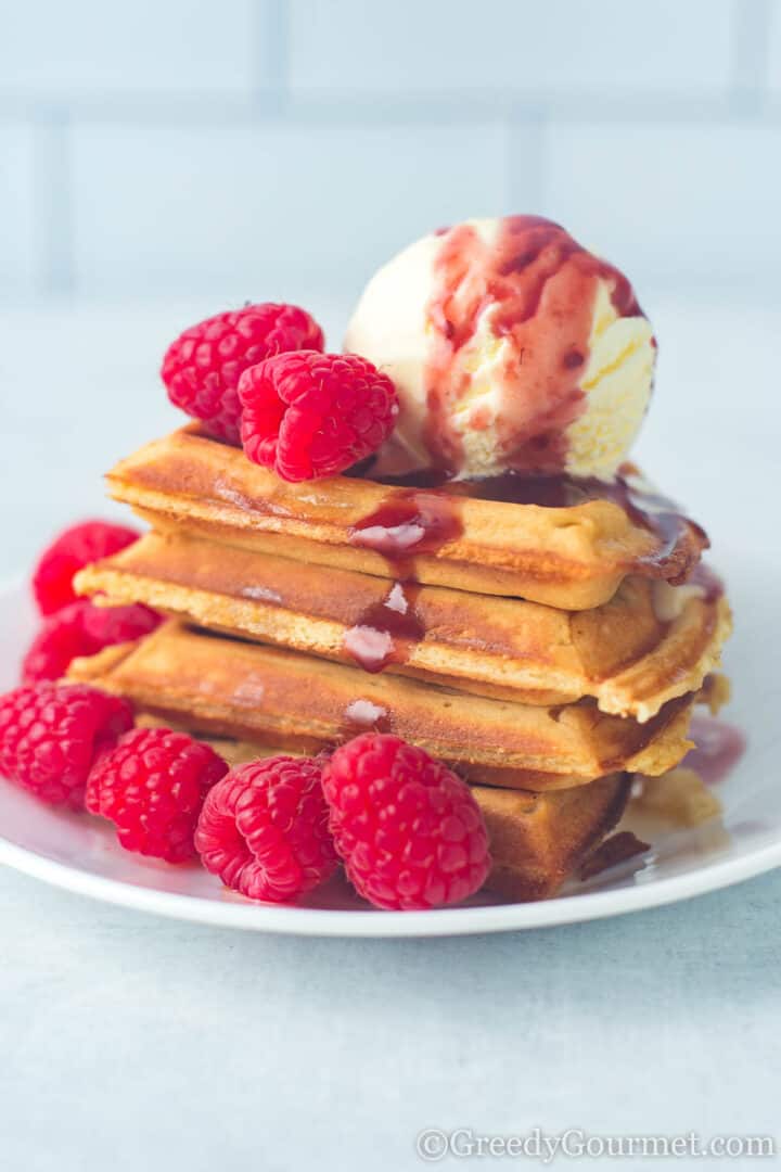 eggnog waffles with ice cream and raspberries.