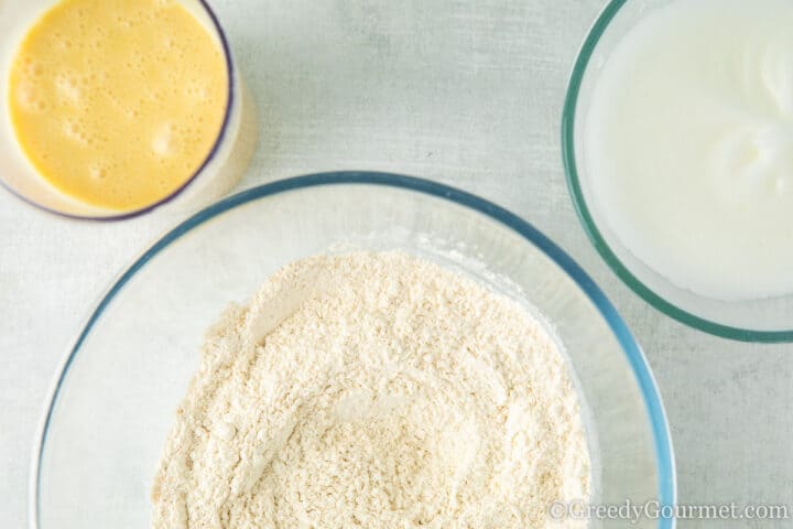 bowls of flour, egg and eggnog.