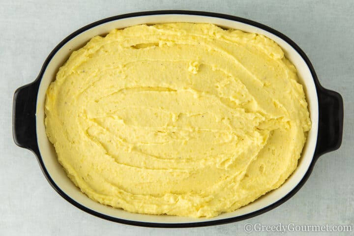 Mashed potato in a serving dish ready to cook.