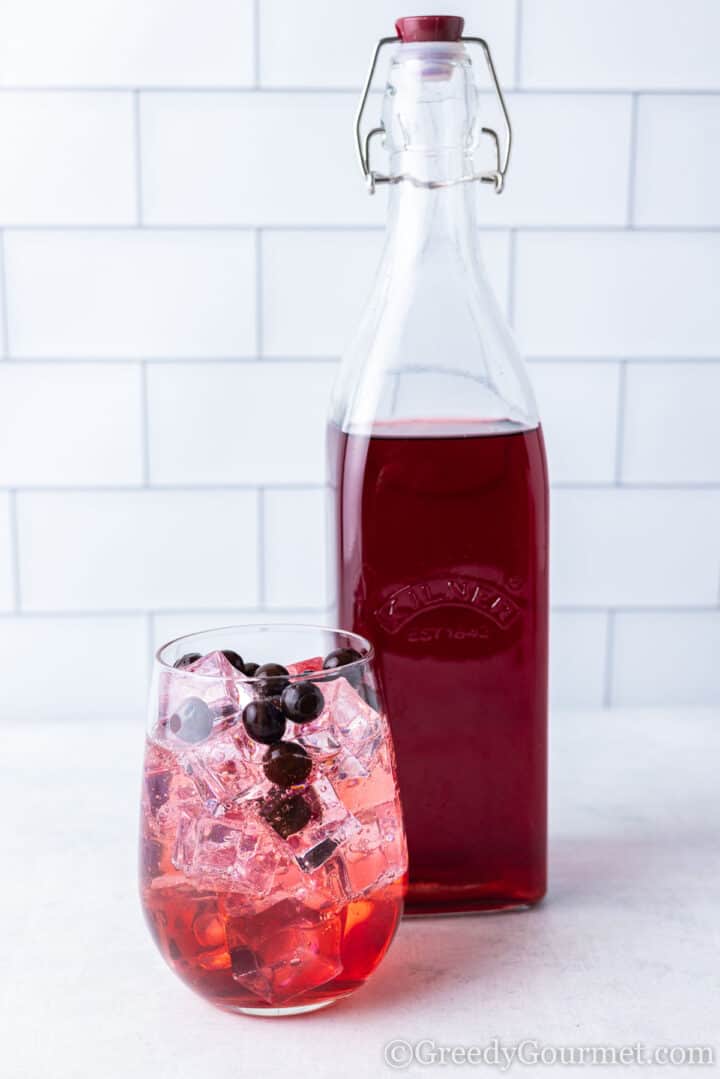 sloe vodka with ice and sloe berries.