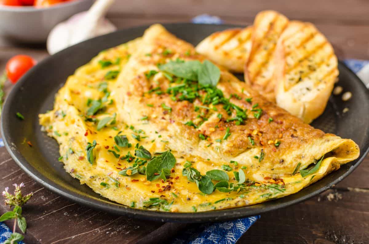Herb omelette sprinkled with chives and chilli flakes.