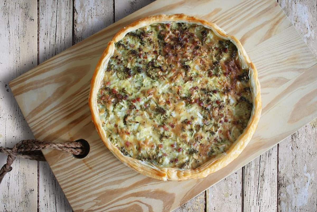 Quiche on a wooden board.