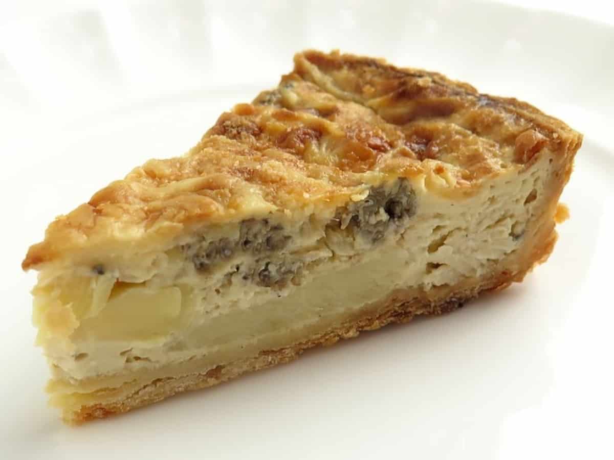 Slice of quiche on a white plate.