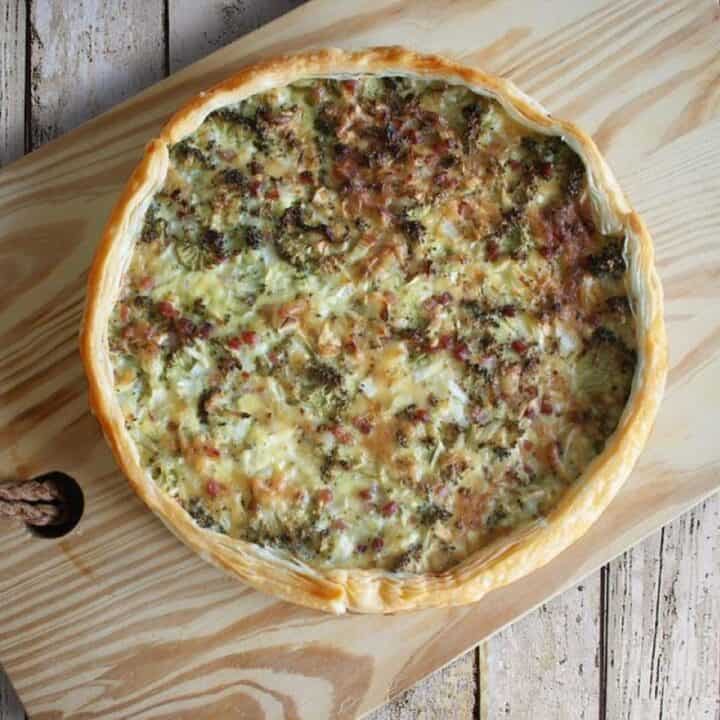 Quiche on a wooden board.