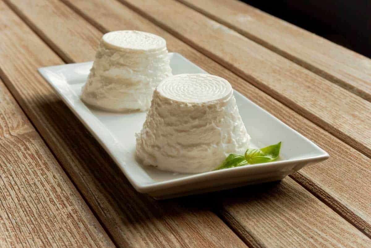 Ricotta cheese on a white plate.