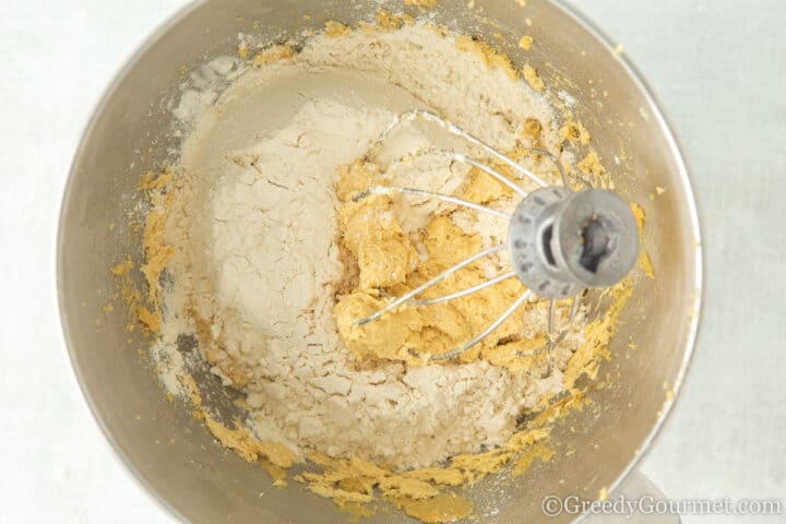 Adding flour to cookie dough.